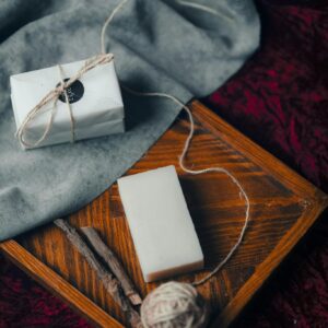 Rustic still life composition featuring handmade soap and twine on a textured background.