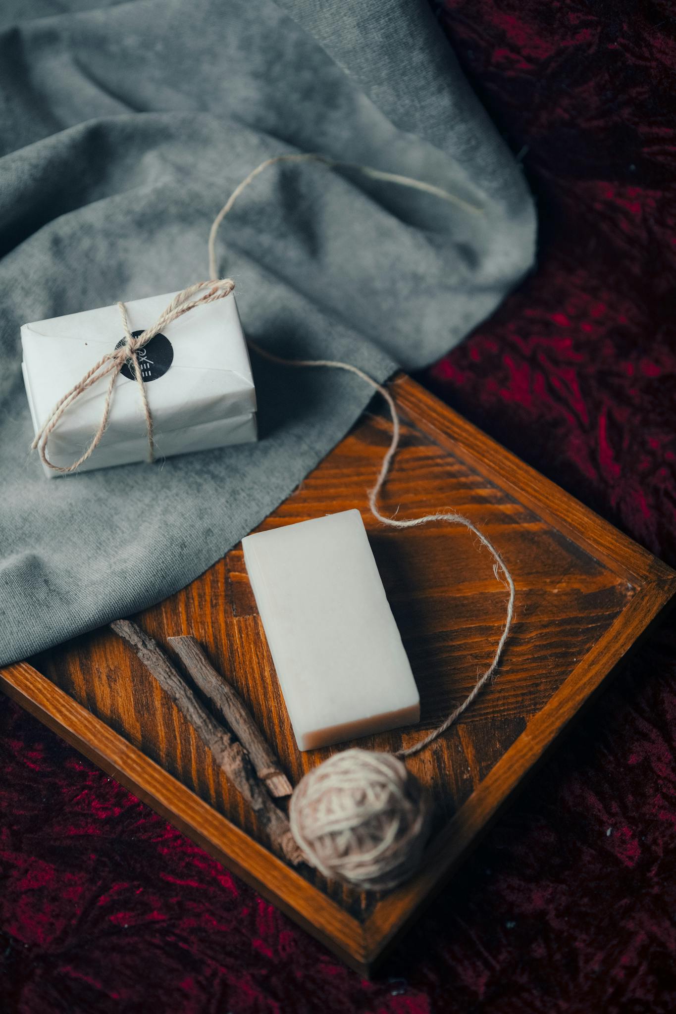 Rustic still life composition featuring handmade soap and twine on a textured background.